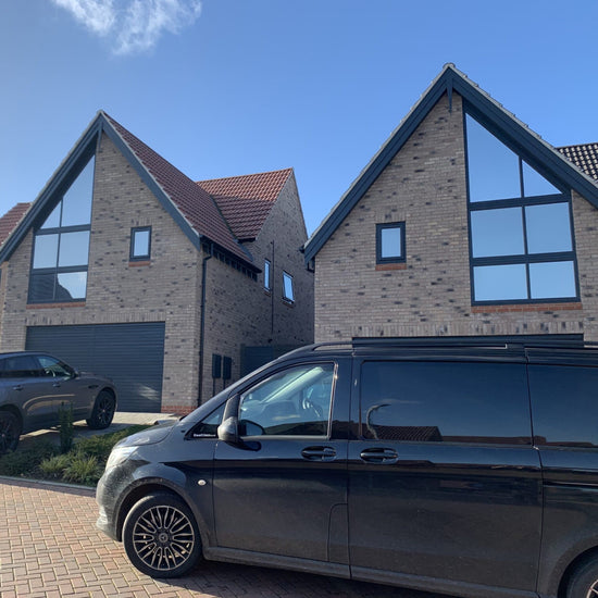 Black van in front of two homes