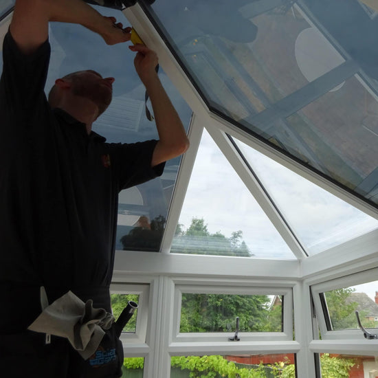 Man fitting window film