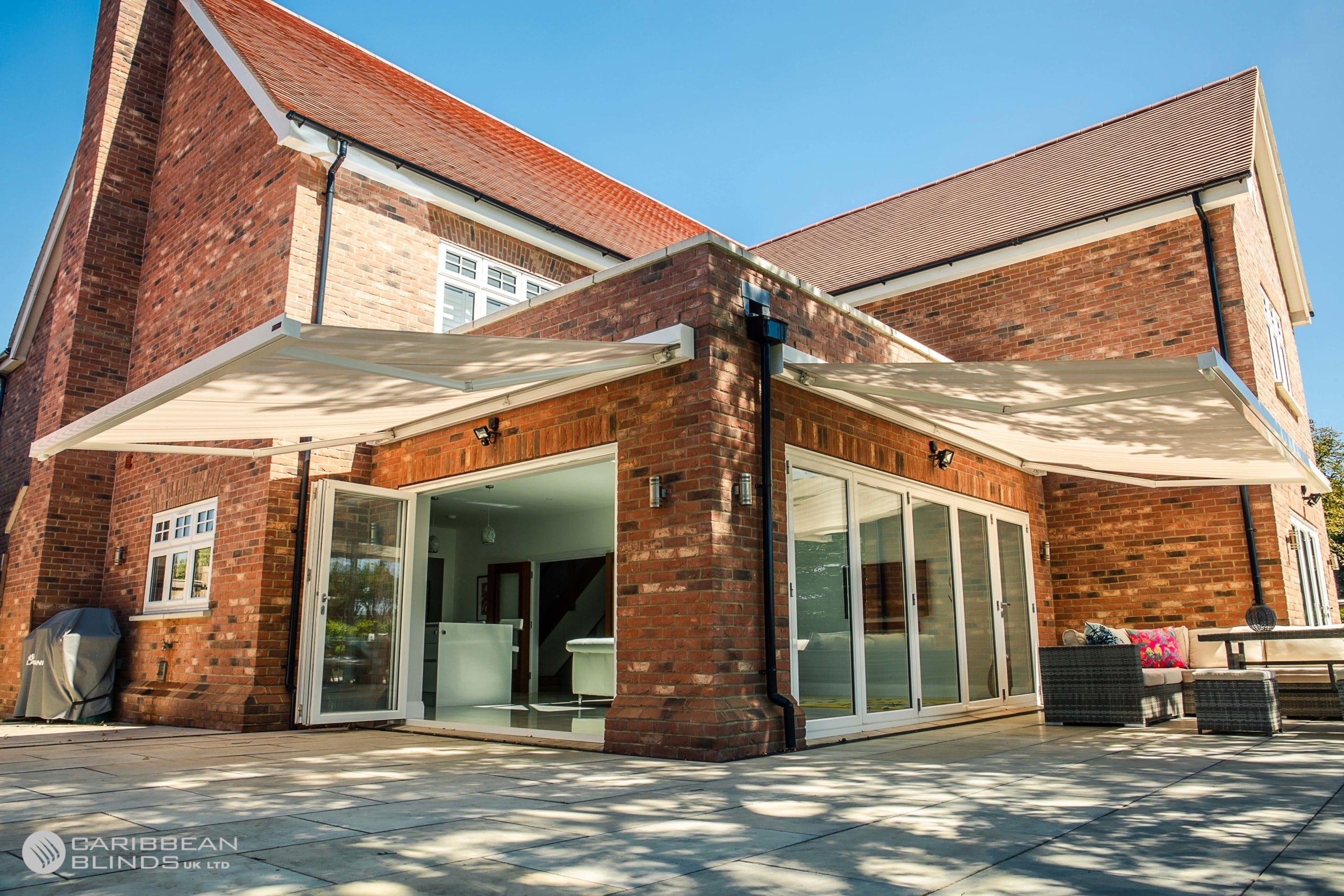 Brick building with outdoor awnings and patio furniture