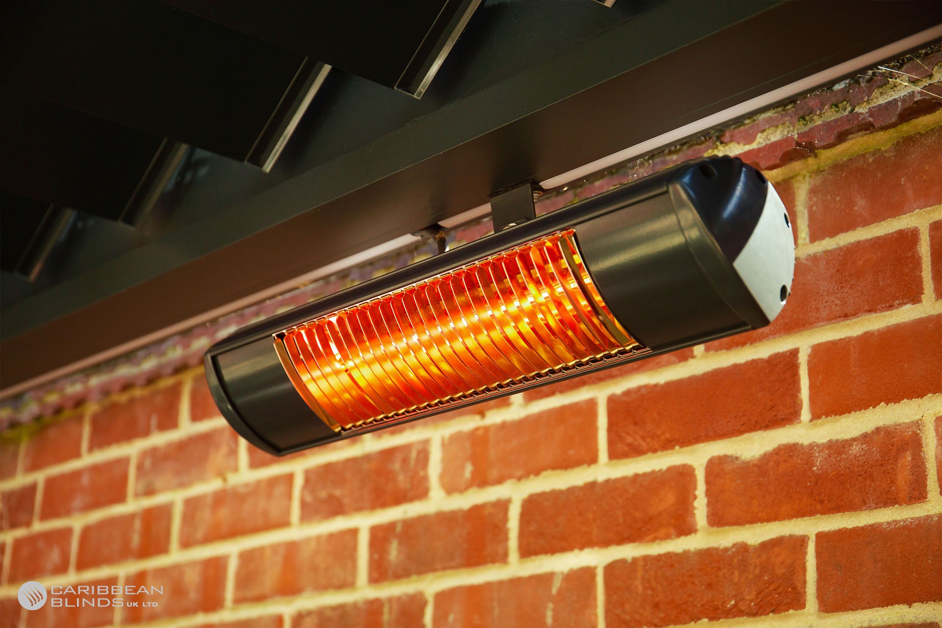 Outdoor patio heater mounted on a brick wall