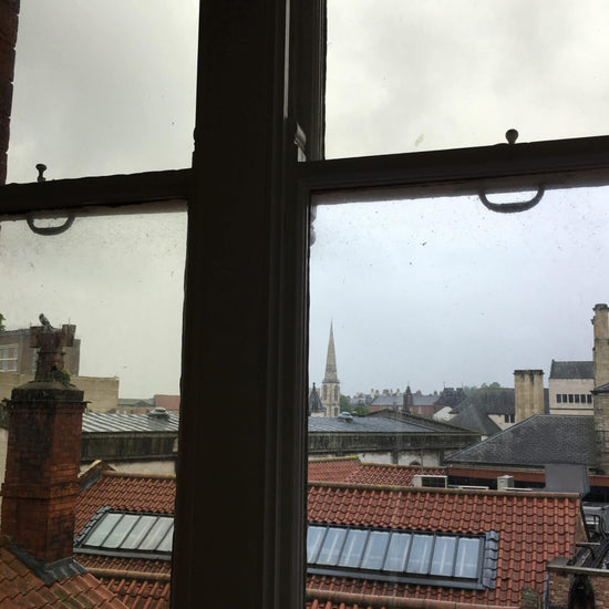 View through window of town rooftops 