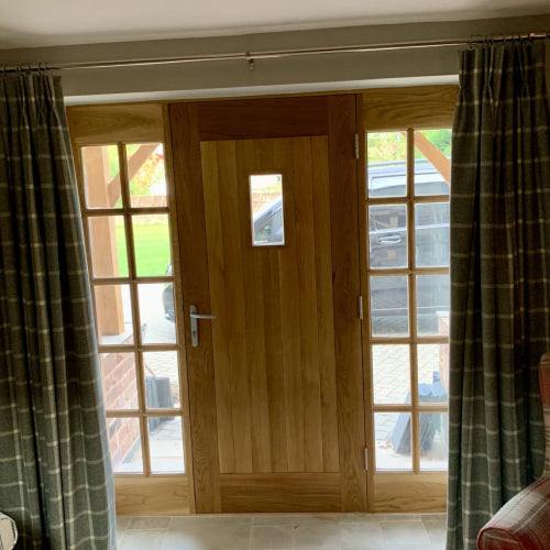 Wooden door with curtains either side