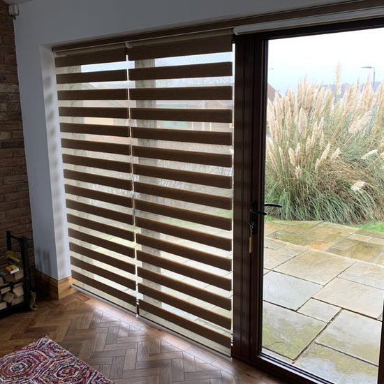 Large window and glass door with blinds